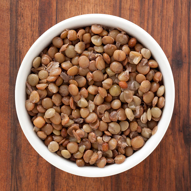 Boiled lentils Top view of white bowl full of boiled lentils lentil photos stock pictures, royalty-free photos & images