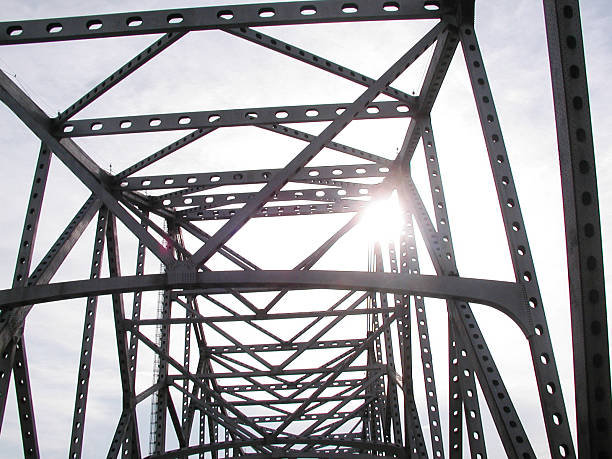 Bridge Tressle "A shot of the sun shining through a bridge tressle in Baton Rouge, LA." tressle stock pictures, royalty-free photos & images
