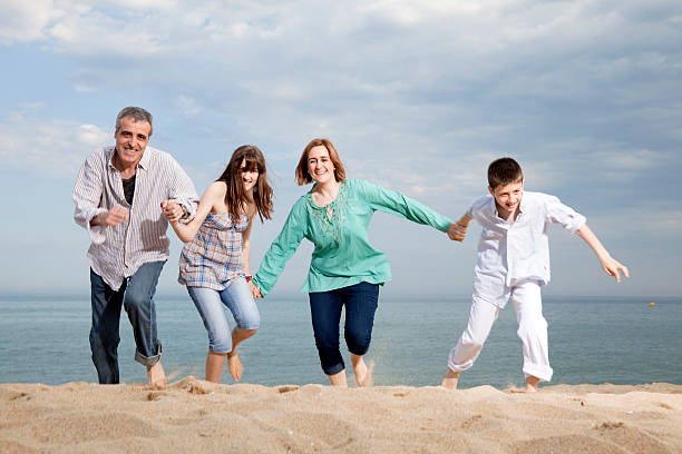 istock Family runnning in a beach 182167417