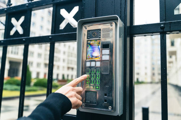 istock Female Hand Operating Video Intercom System, Dialing Apartment Number in Urban Residential Complex 1821674337