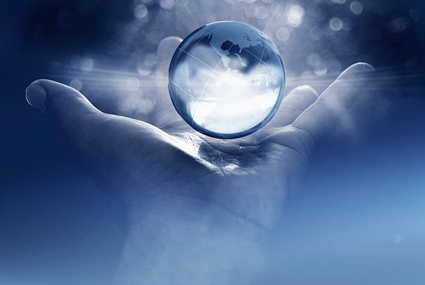 world domination; the future is in your hands glass globe of earth in open human palm in monochrome repression stock pictures, royalty-free photos & images