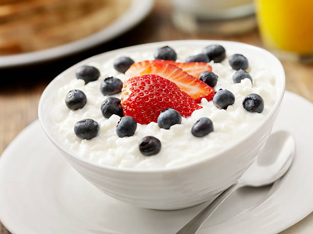 Cottage Cheese with Fresh Fruit "Cottage Cheese with Fresh Strawberry's and Blueberry's, Orange Juice, Milk and Whole Wheat Toast- Photographed on Hasselblad H3D2-39mb Camera" curd cheese photos stock pictures, royalty-free photos & images