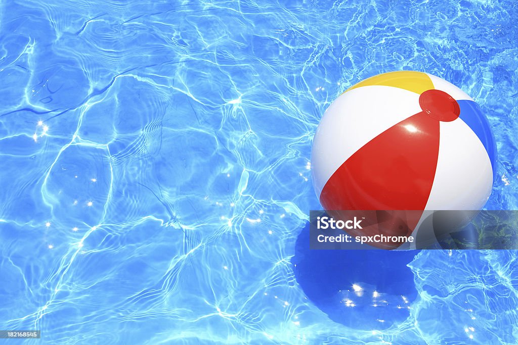 Beach Ball Beach ball floating in a pool with small waves reflecting in the summer sun. Beach Ball Stock Photo