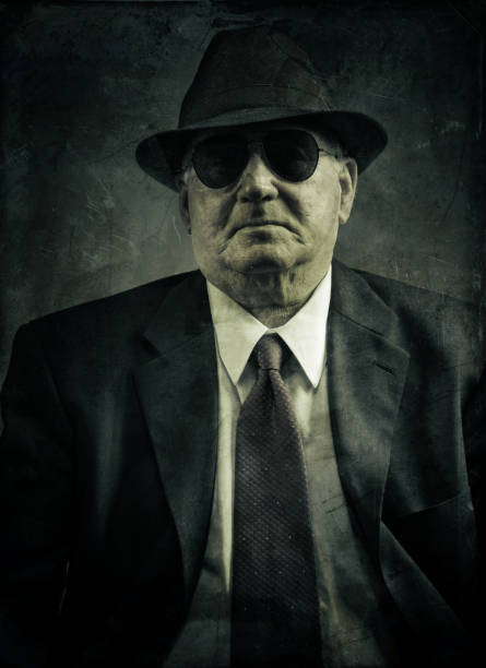 confident omerta boss omerta business man - mafia boss, head and shoulder portrait composite with some grunge old pieces of papers mafia boss stock pictures, royalty-free photos & images