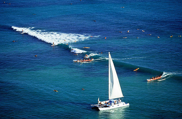 USA Hawaii O'ahu, Waikiki. "USA Hawaii O'ahu, Waikiki, with surfing, canoes, and catamarans." outrigger stock pictures, royalty-free photos & images