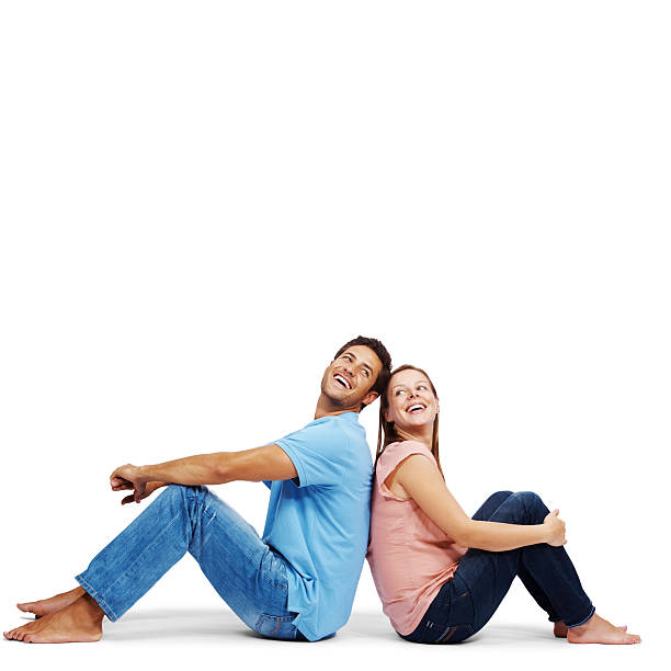 istock Young, love couple sitting back-to-back with lots of copyspace 182170268