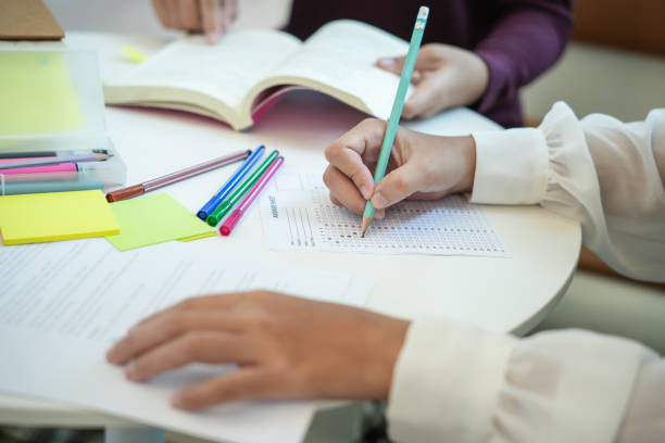istock Learning with friends Young students campusHigh School Tutor for examining helps school homework together withÂ friend catching up and learning 1821707314