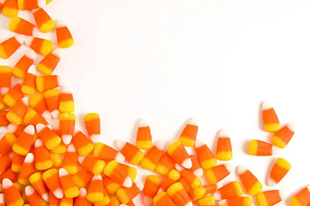 Photo of Orange and yellow candy corn set against a white background