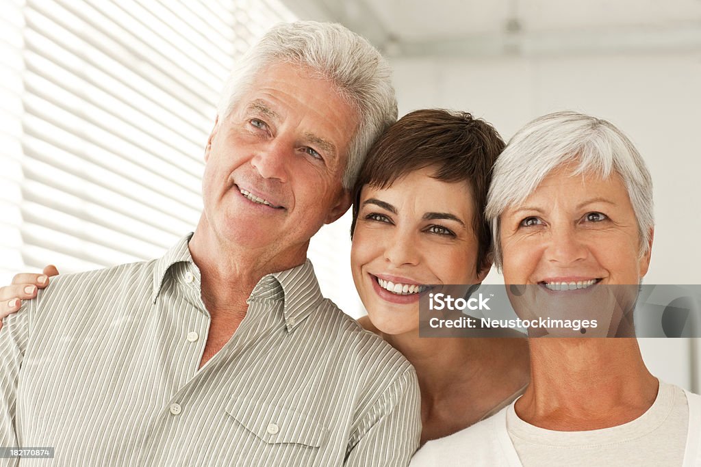 Happy family with arm around Happy family standing together with arm around while looking away 60-69 Years Stock Photo