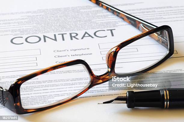 Pair Of Reading Glasses Resting On A Contract With Pen Stock Photo - Download Image Now