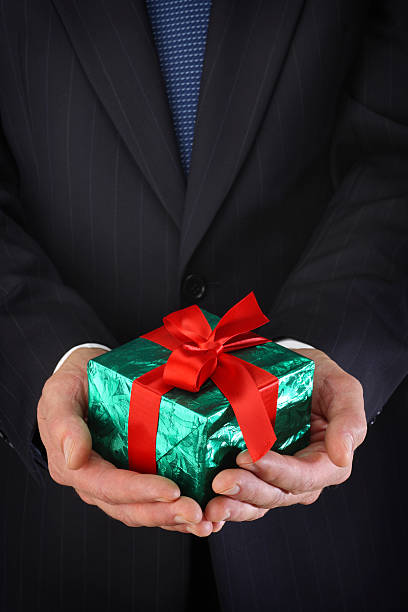 istock Businessman Holding Christmas Gift 182171496