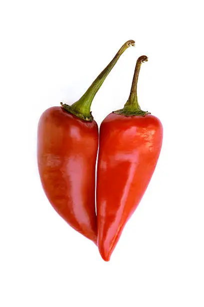 Two hot peppers make the shape of a heart isolated on a white background.Other versions: