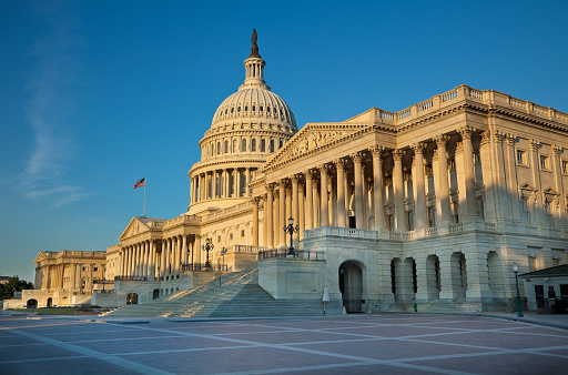 The east side of the US Capitol at sunrise. Senate Chamber in foreground.