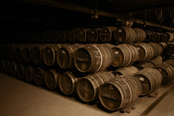 Barrels Rows of barrels stacked on top of each other in a dark cellar. whisky cellar stock pictures, royalty-free photos & images