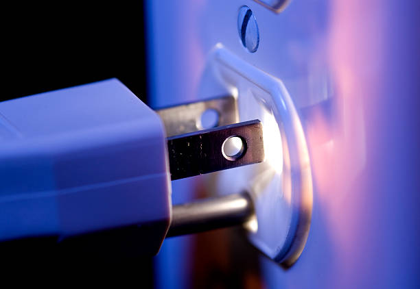 Glowing Electric Outlet and Plug An electric outlet glowing from within and a three prong electric plug and cord. wired stock pictures, royalty-free photos & images