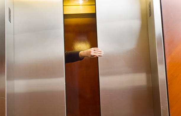 Holding the elevator door stock photo