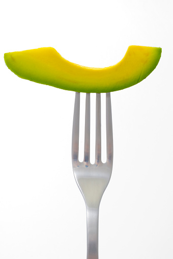 Slice of fresh avocado on a fork