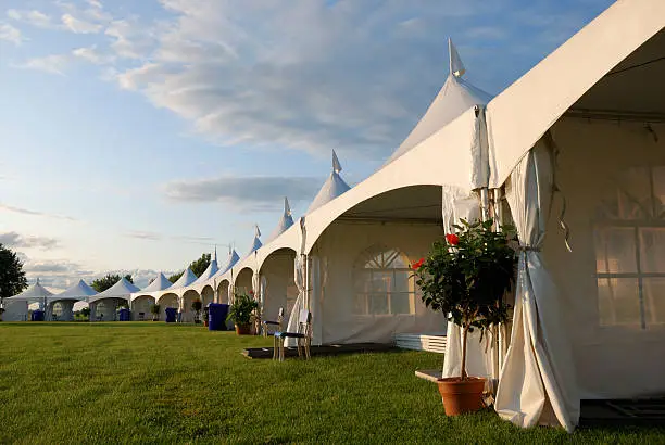 Perspective on a row of tent for a ceremony.