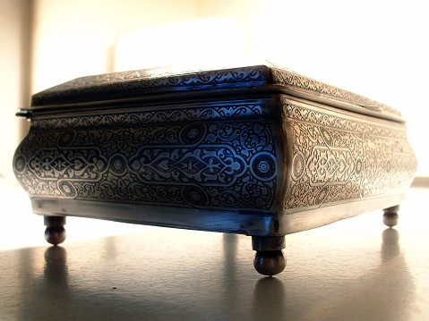 A silver box with arabian and Indian pattern on it.
