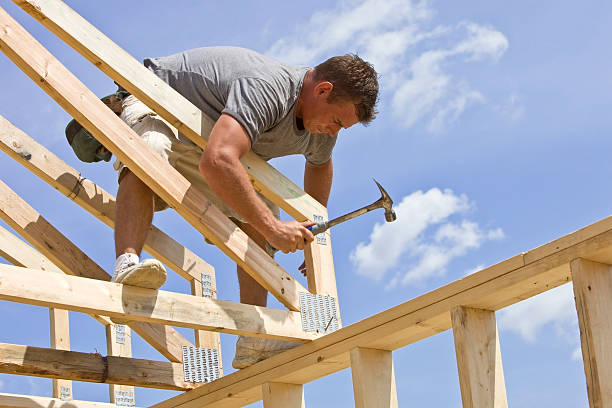 istock Builder Hammering Roof Truss Nail Against Blue Sky 182173398