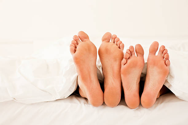 istock Couple sleeping in bed, focus on their feet 182173433