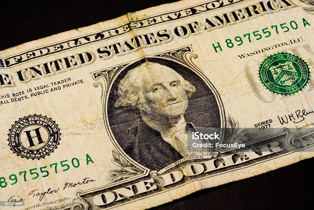 One Dollar One Us Dollar with George Washington on it. It looks very used. Banking Stock Photo