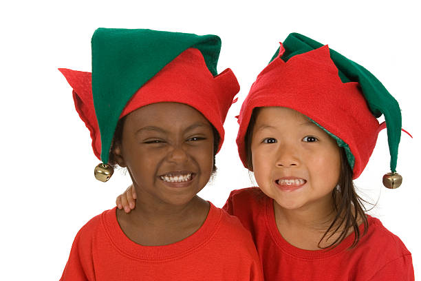 Cute Christmas Elves Adorable preschoolers wearing ready for Christmas and wearing elf hats bell photos stock pictures, royalty-free photos & images