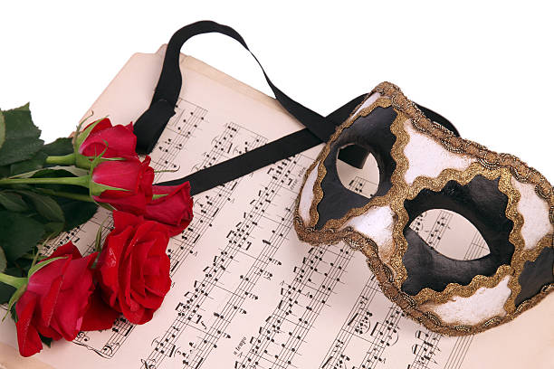 Venetian mask, notes and flower. stock photo