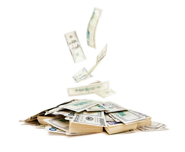istock Banknotes falling on a pile of money. 182174180