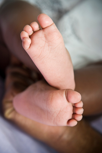 close up of african american baby's cute tiny feet