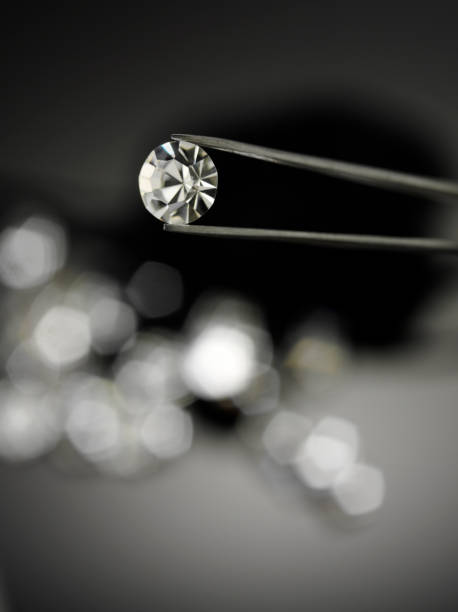 istock Holding a Diamond with Jewellery Tweezers 182174336