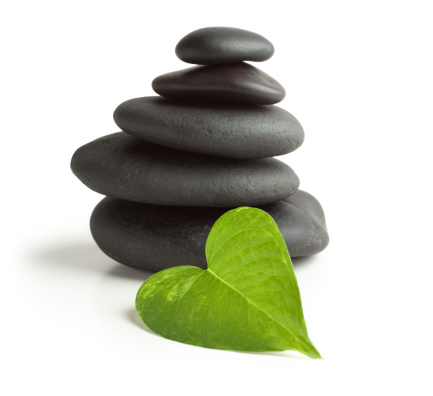 Balanced black massage stones and heart-shaped leaf. You may also like: