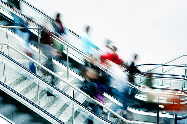 istock Crowd of Blurred People on Stairs and Escalator 182174370