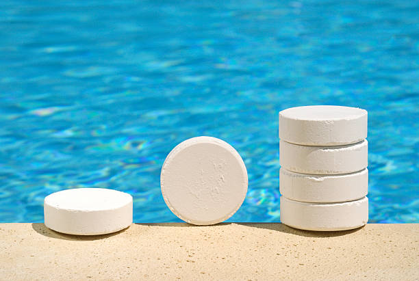 Swimming Pool Water Treatment with Chlorine Tablets Chlorine tablets - commonly used to sanitize swimming pool water chlorine stock pictures, royalty-free photos & images