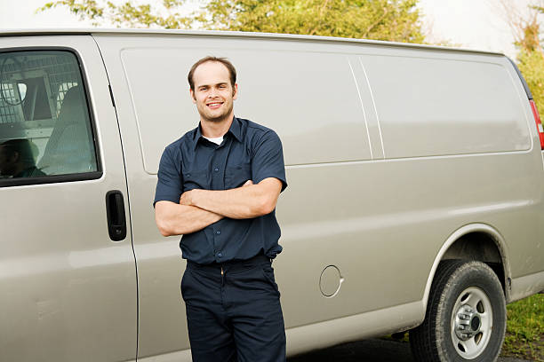 istock Man in Industrial Uniform Standing Next to Service Van 182174421