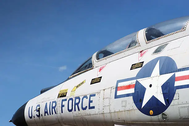 Jet fighter cockpit against sky