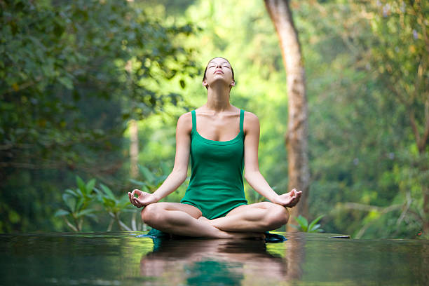 Yoga "Woman doing yoga, canon 1Ds mark III" yoga lotus position meditating women stock pictures, royalty-free photos & images