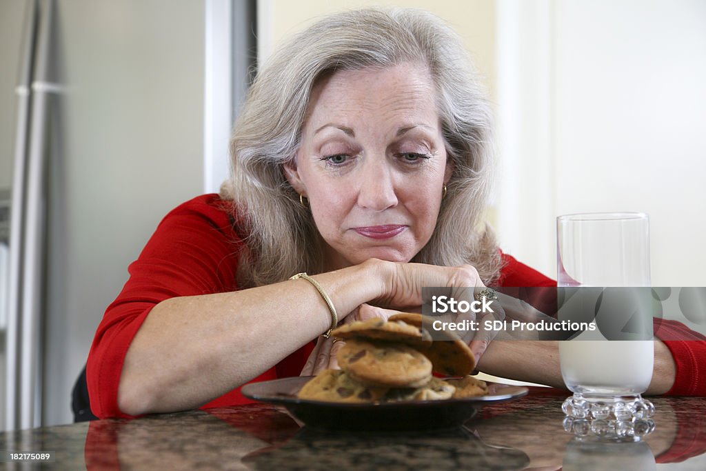 Senior Adult Woman Wishing She Could Eat Cookies and Milk Senior Adult Woman Wishing She Could Eat Cookies and Milk.See more from this series: Mature Women Stock Photo