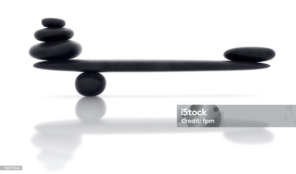 Balancing smooth black stone with reflection Royalty-free image of piled shiny pebbles in perfect balance. Balance Stock Photo