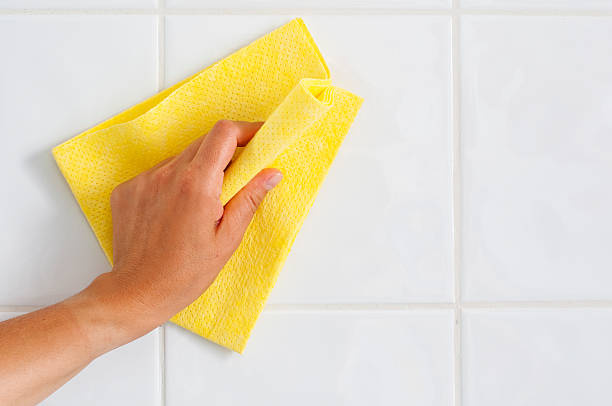 Cleaning Stock photo of hand cleaning wall with rag rag stock pictures, royalty-free photos & images