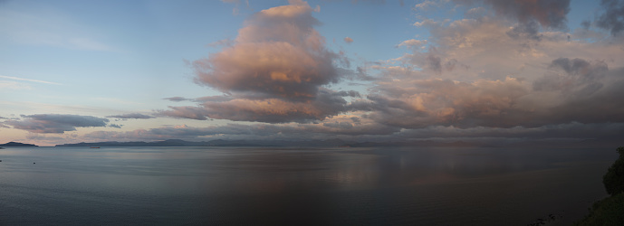 Beautiful golden sea sunrise with dramatic pastel sky reflecting in the water, Avachinskaya bay panoramic view, Kamchatka