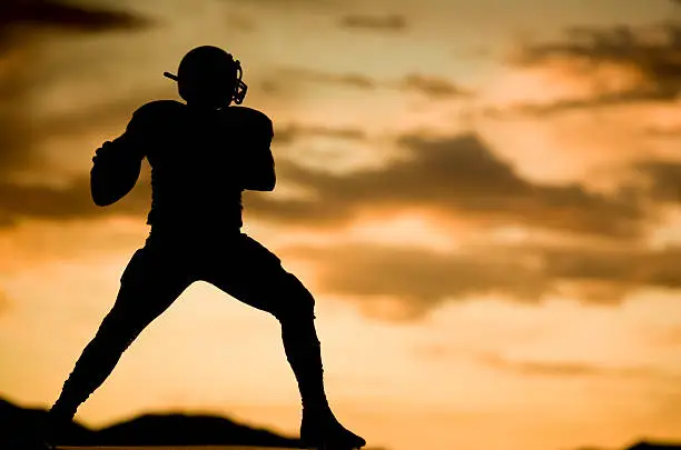 silhouette shot of football players