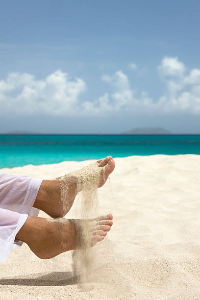 beautiful feet and sand in motion on a tropical beach