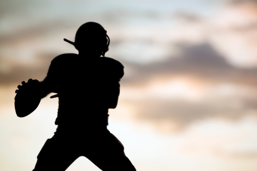 silhouette shot of football players