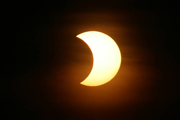 the nights sky with a partial solar eclipse - eclipse stockfoto's en -beelden