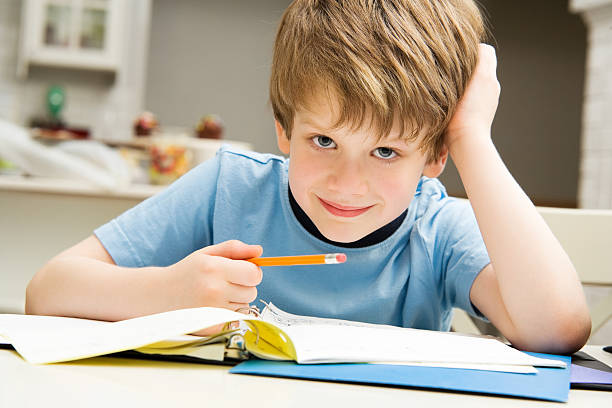 istock Boy Child Doing Home Work in Kitchen Lifestyle School Education 182176515