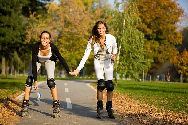 "Women rollerblading together, canon 1Ds mark III"