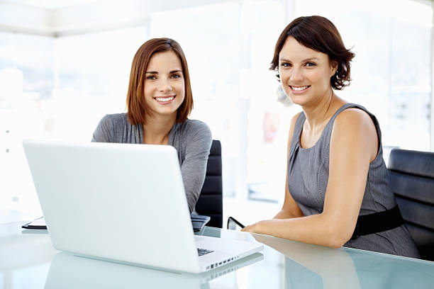 istock Smiling female executives with laptop 182176579