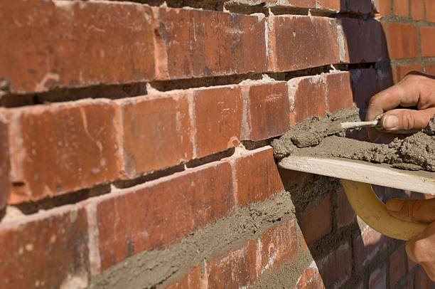 Bricklayer Repointing Old Bricks stock photo