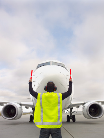 A ground crew member taxis in a large commercial jet.View more aviation themed images from my portfolio here: